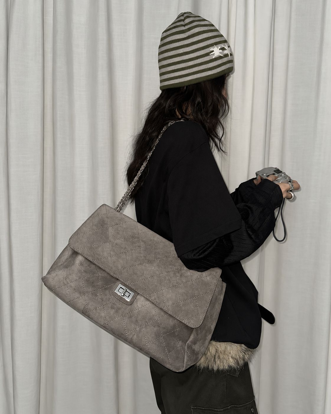 Quilted diamond-stitch flap shoulder bag with double silver chain strap and turn-lock closure in suede-look finish, detail