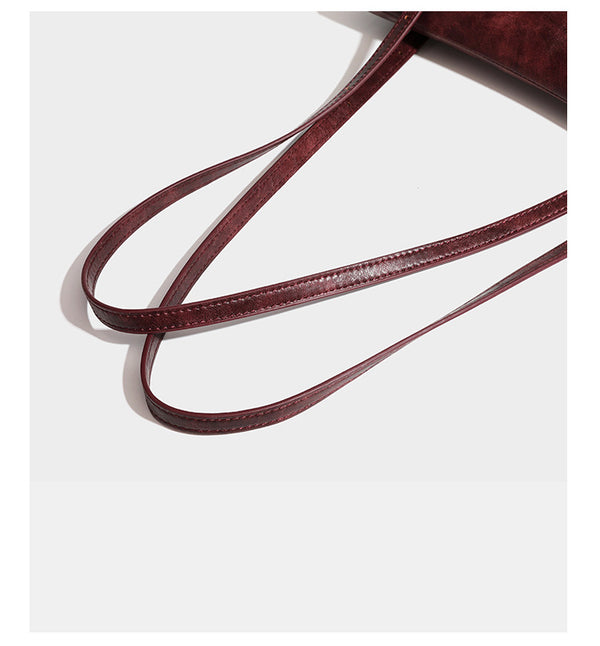 Large structured shoulder tote bag in wine red textured leather-look finish with front flap closure and silver-tone buckle