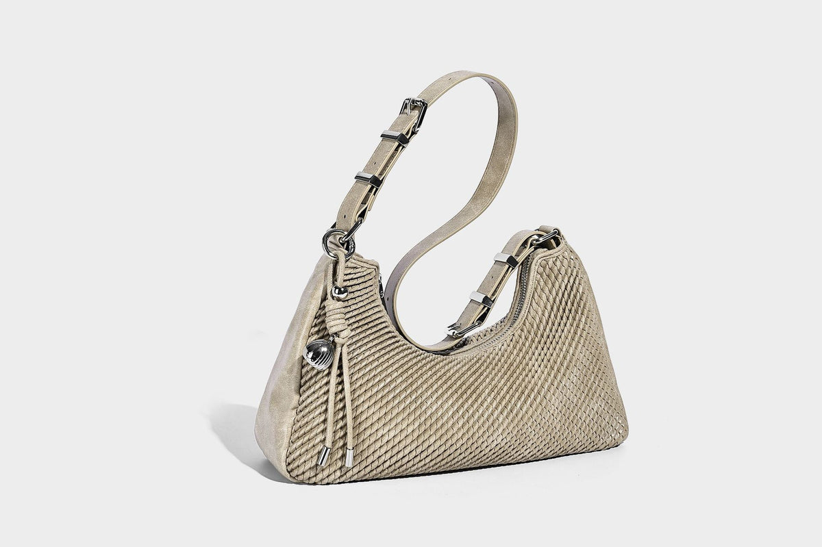 Woven crescent hobo shoulder bag with smooth side panels, zip-top closure, silver-tone charm hardware, and adjustable, detail
