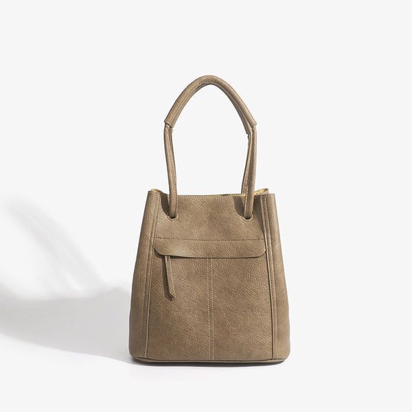 Retro structured matte leather-look tote bag in camel with front flap pocket, tassel pull, and double top handles, detail