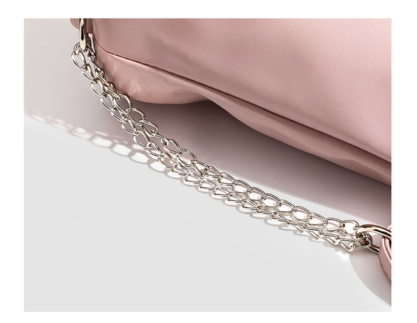 Glossy leather-look hobo shoulder bag with front bow lacing detail and silver-tone chain strap, detail view 12