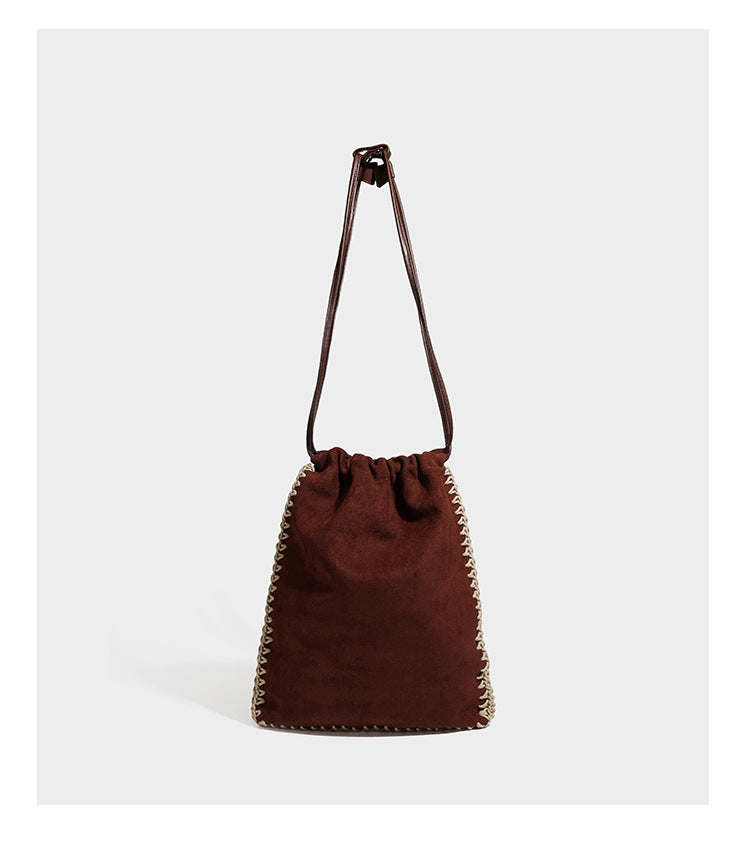 Matte suede-look drawstring bucket bag with cream braided woven edge trim and slim adjustable leather-look shoulder strap