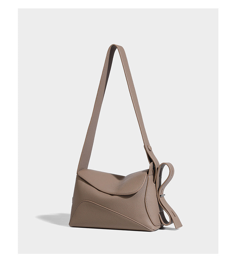 Structured curved-flap pebbled PU shoulder bag with sculptural loop strap detail, detail view 11