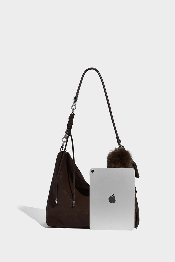Slouchy matte-finish hobo shoulder bag with tassel cords, silver-tone hardware, and faux-fur pom charm, detail view 27