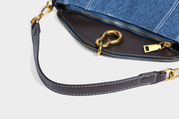 Slouchy denim shoulder bag with dark leather-look trim, gold-tone chain-link hardware, and top zipper closure, detail view 35