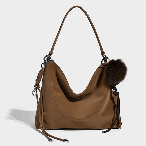 Slouchy matte-finish hobo shoulder bag with tassel cords, silver-tone hardware, and faux-fur pom charm, detail view 3