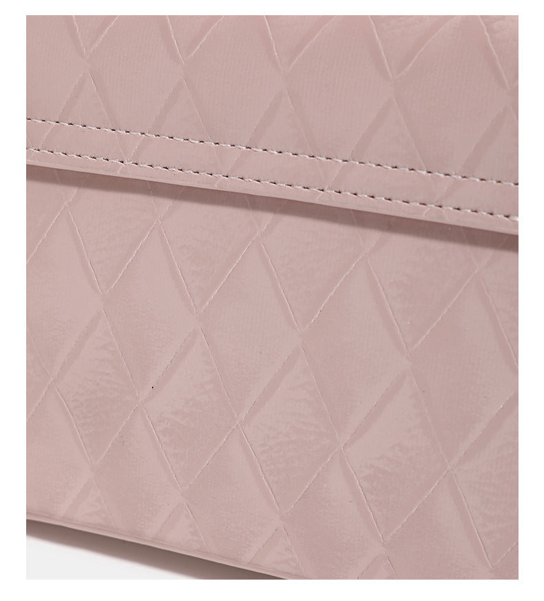 Small structured diamond-quilted flap bag with gold-tone turn-lock closure, chain shoulder strap, and cylindrical top handle