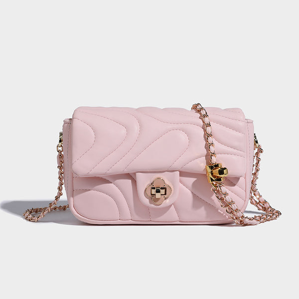 Compact cream quilted flap crossbody bag with wave stitching, gold-tone chain strap, and four-petal turn-lock clasp, detail