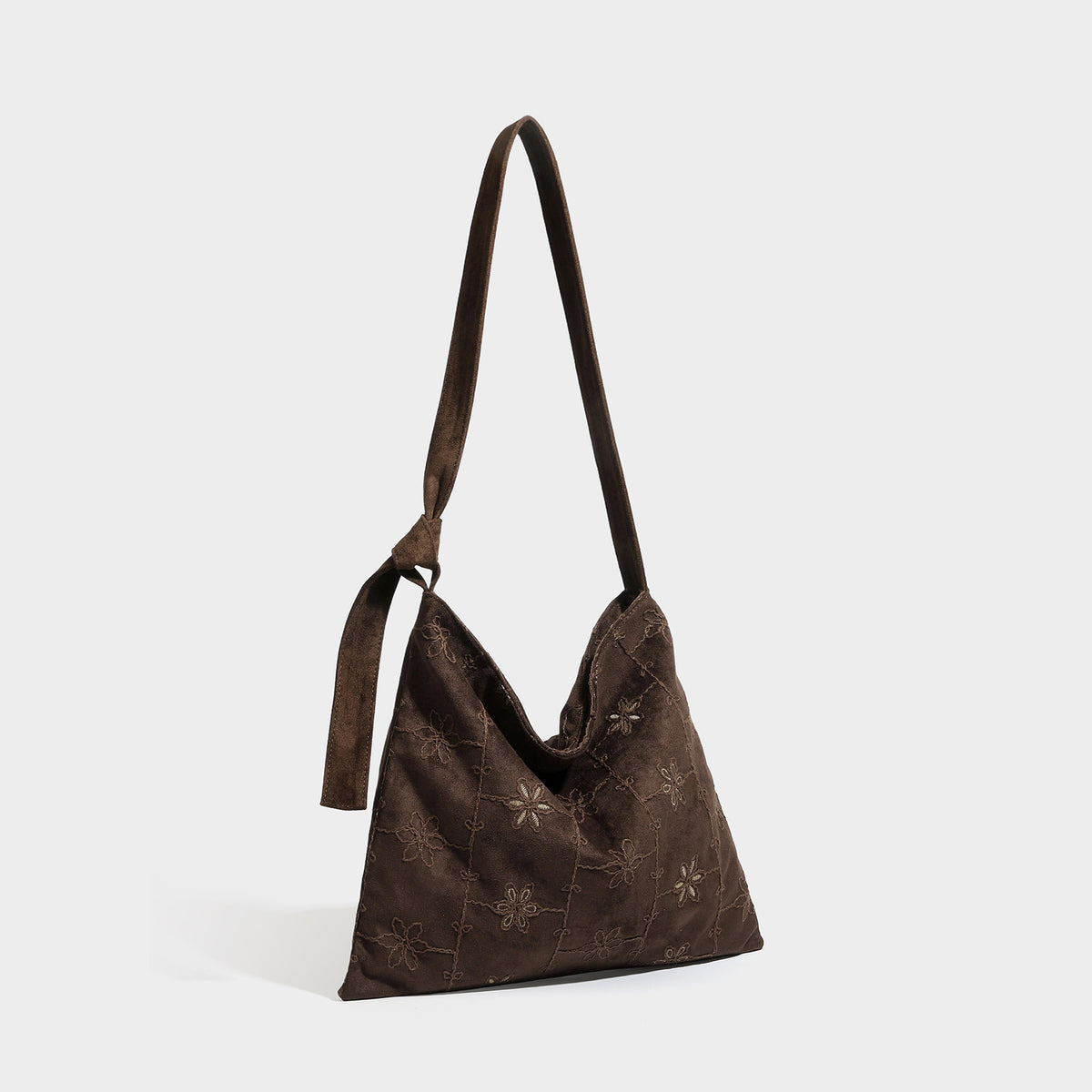Lässig weich fallende Hobo-Schultertasche in dunkelbrauner Velourslederoptik mit Ton-in-Ton-Blumenstickerei und langem, geknotetem Einzelriemen, Detailansicht