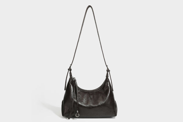 Slouchy hobo shoulder bag in glossy crinkled leather-look finish with zip-top closure and silver-tone ring hardware, detail