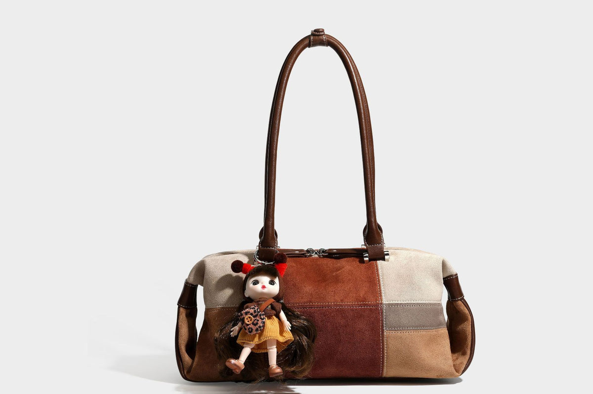 Patchwork suede-look barrel shoulder bag in brown, rust, tan, beige, and gray panels with double leather-look straps and