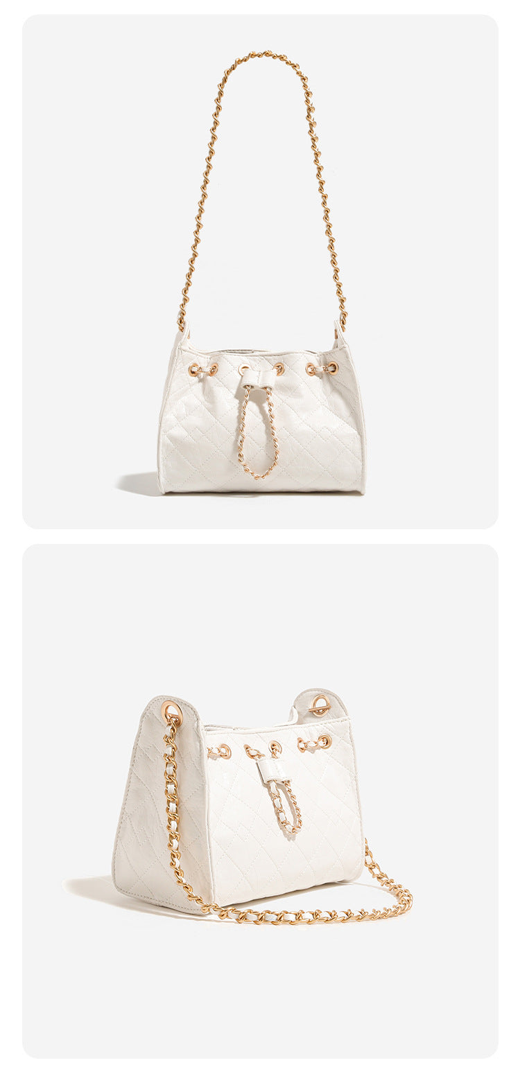 Glossy diamond-quilted drawstring bucket bag with gold-tone chain strap and eyelet hardware, detail view 14
