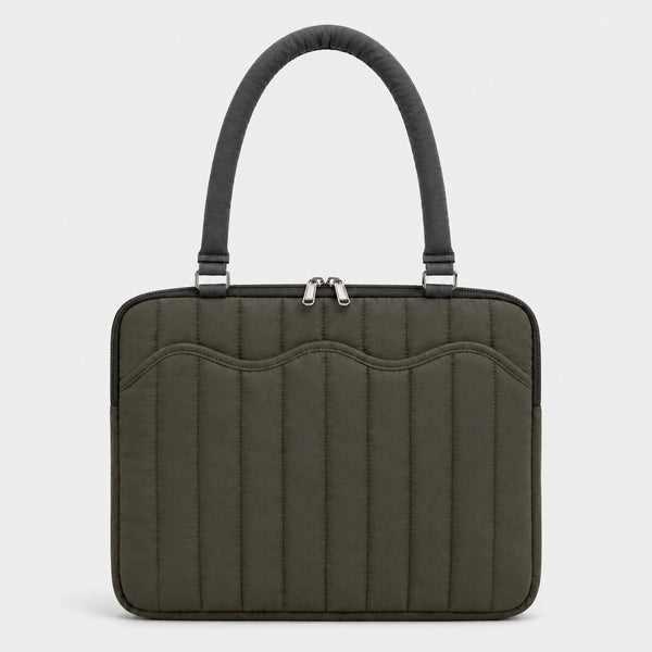 Quilted colorblock handbag with wavy scalloped front panel, padded arched top handles, and dual zip closure, detail view 10