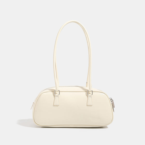 Rounded baguette shoulder bag with glossy leather-look finish, double-pull zip top, dual top handles, and silver-tone, detail