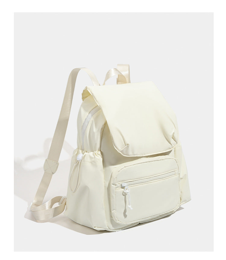 Soft matte nylon flap backpack with front zip pocket and side drawcord pockets, detail view 10