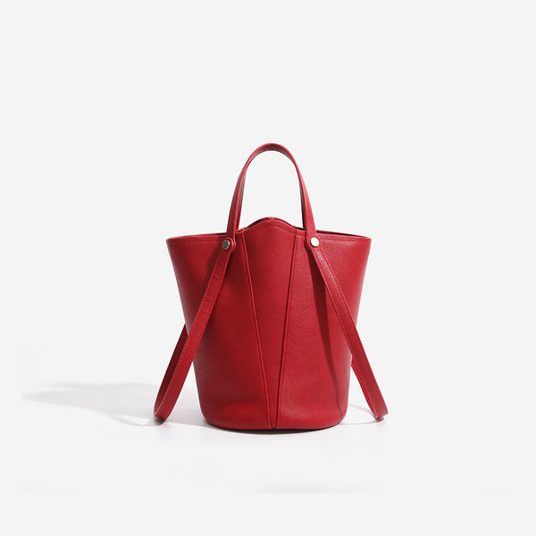 Large leather-look bucket tote bag with dual top handles and adjustable crossbody strap, front view