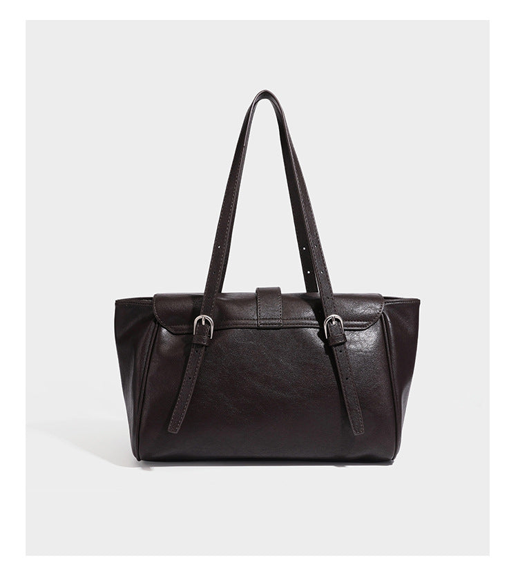 Large structured vintage-style tote bag with flap-front turn-lock closure, twin buckle straps, and double shoulder handles