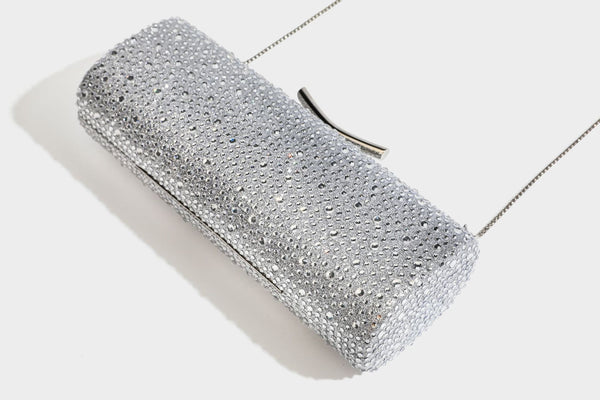 Structured rectangular hard-case clutch bag covered in all-over rhinestone crystal embellishment with curved kiss-lock top