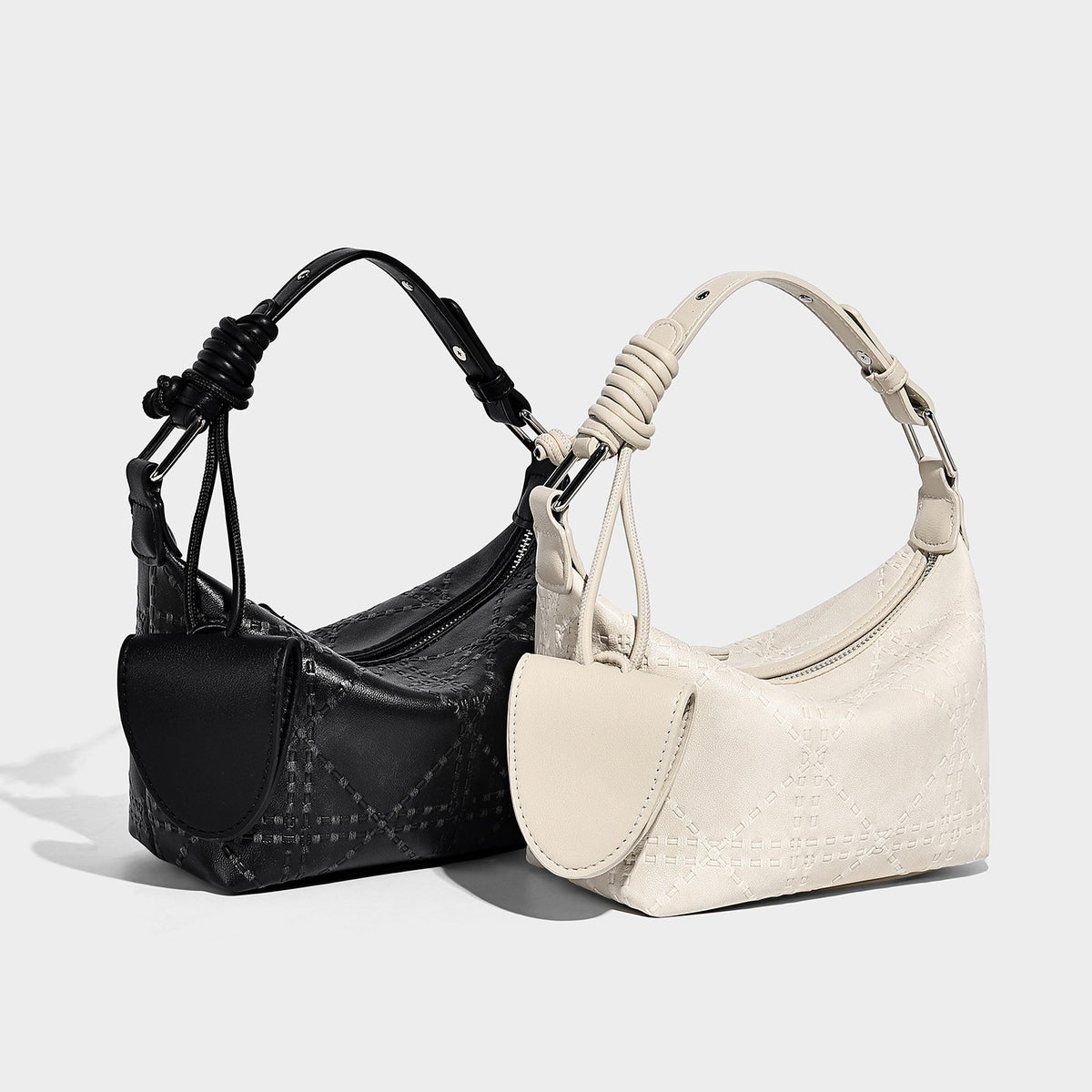 Small embossed half-moon shoulder bag with top zipper, detachable front pouch, and adjustable slim strap, detail view 2