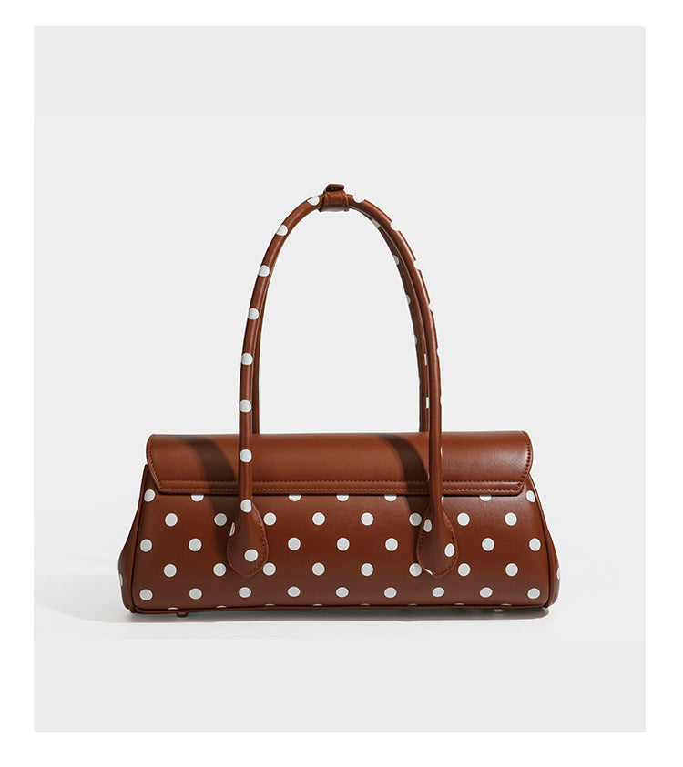 Strukturierte Baguette-Tasche mit Polka-Dot-Muster, glänzender Lederoptik, zwei Tragegriffen, silberfarbener Drehverschlussklappe und