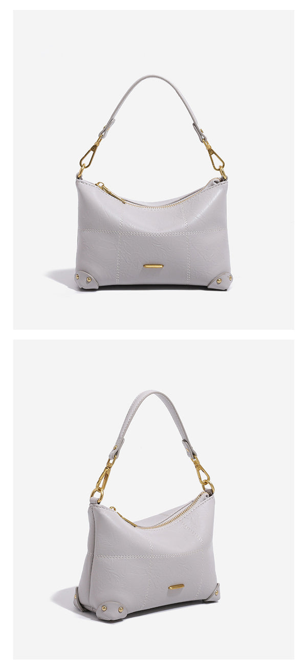 Small soft-structured shoulder bag with curved zip closure, stitched panel detailing, and gold-tone hardware, detail view 12