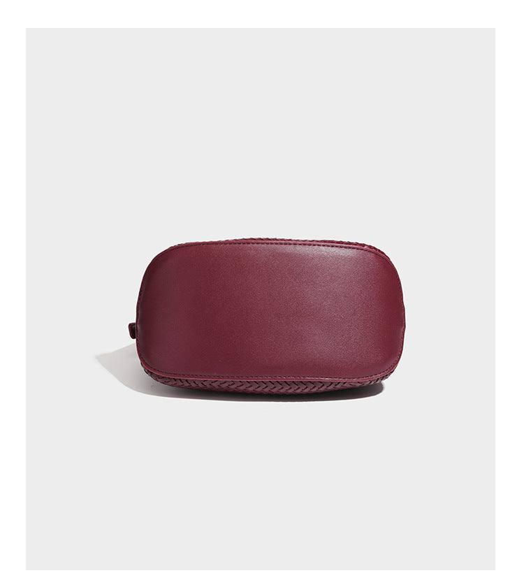 Small woven-look leather-look flap shoulder hobo bag in burgundy with silver-tone hardware and decorative tassel charm
