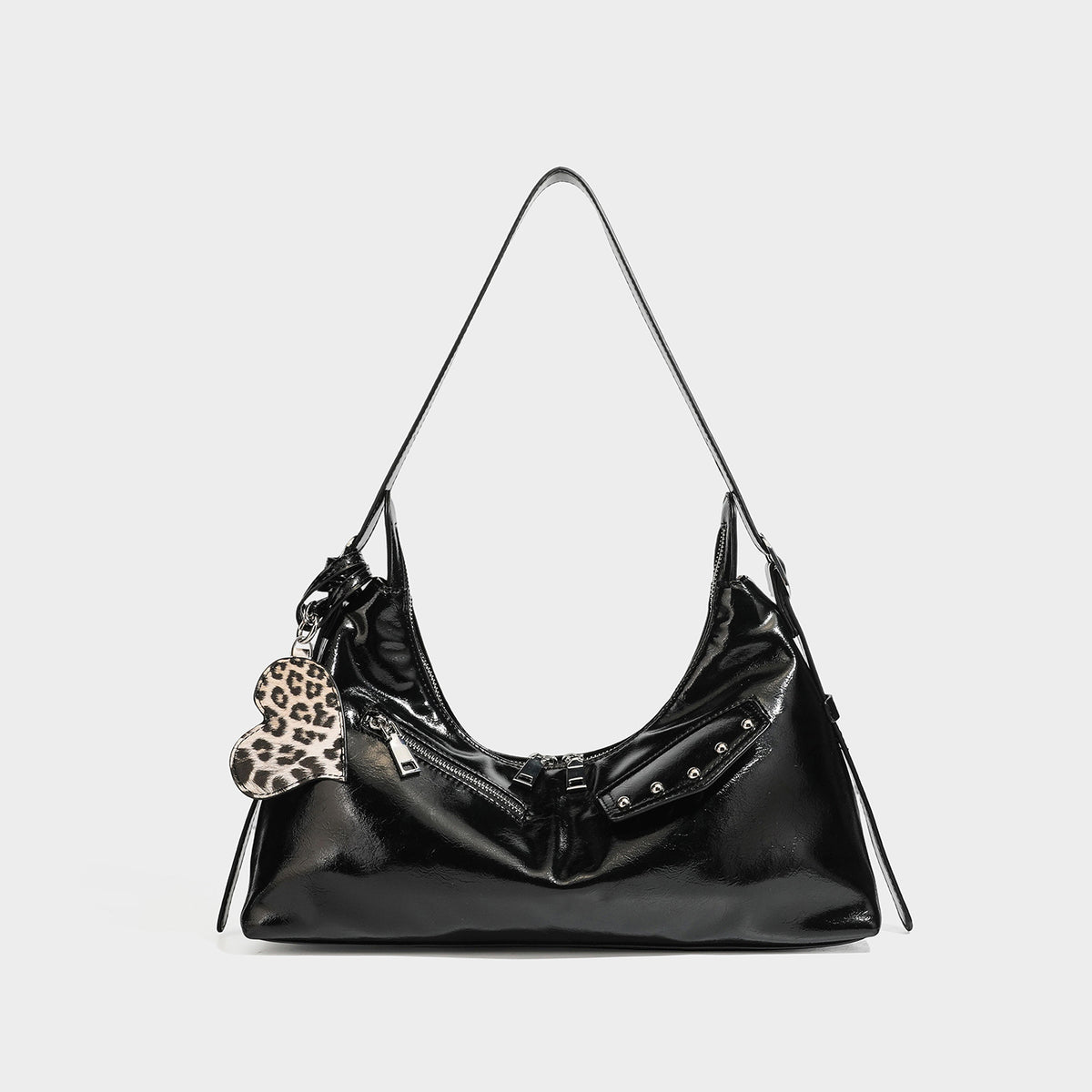 Glossy dark brown hobo shoulder bag with slim strap, front zip pocket, stud detail, and detachable leopard-print heart charm