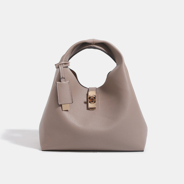 Structured pebbled leather-look bucket tote with gold-tone turn-lock hardware and looped top handle, front view