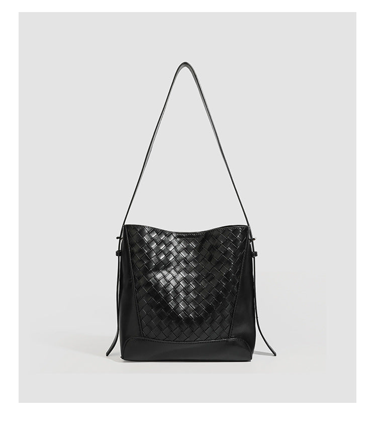 Large black bucket shoulder bag with diamond woven leather-look front panel, smooth side panels, magnetic snap closure, and