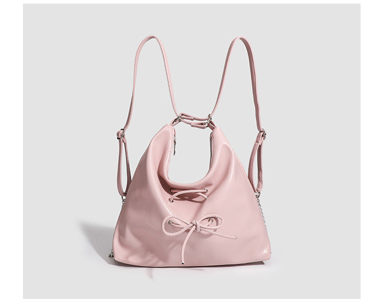 Glossy leather-look hobo shoulder bag with front bow lacing detail and silver-tone chain strap, detail view 17
