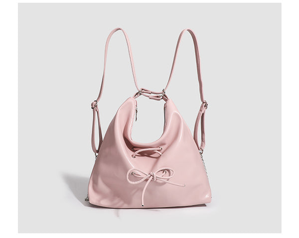 Glossy leather-look hobo shoulder bag with front bow lacing detail and silver-tone chain strap, detail view 17