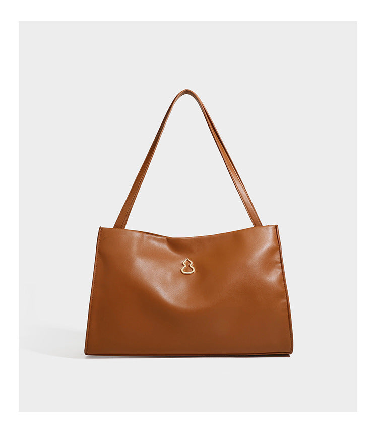 Structured rectangular shoulder tote bag with smooth leather-look finish, long double straps, and gold-tone gourd emblem on