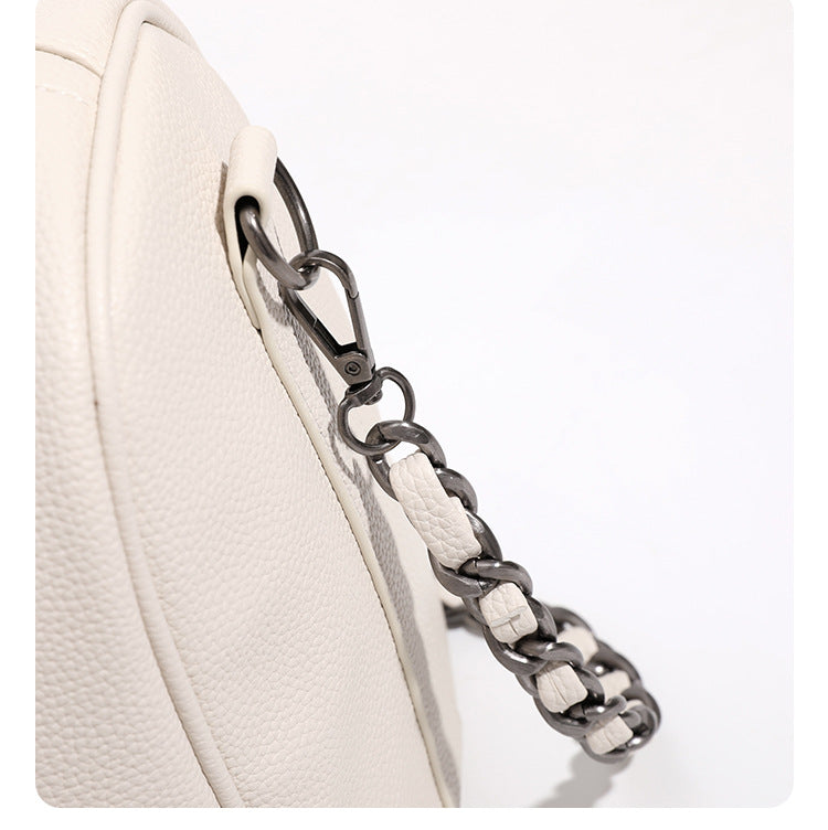 Large cream white pebbled leather-look barrel travel bag with twin top handles, chunky chain shoulder strap, front zip