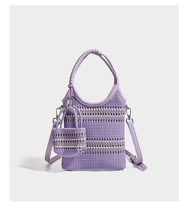 Color-block woven tote bag with rounded leather-look handles, detachable crossbody strap, and matching mini clip-on pouch in