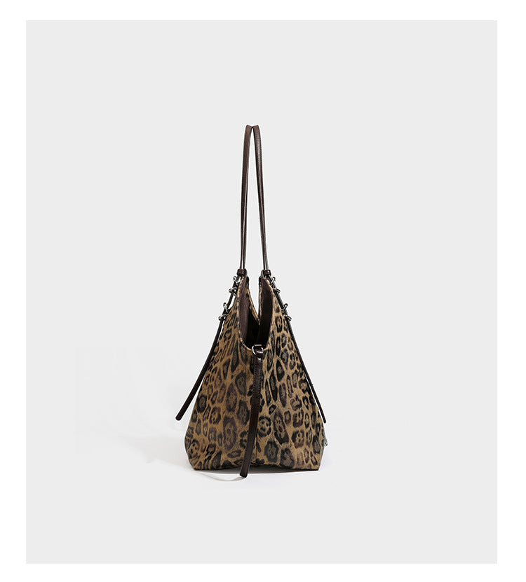 Slouchy leopard-print shoulder tote bag in tan and brown with long double straps, side tie straps, and dangling charm, detail