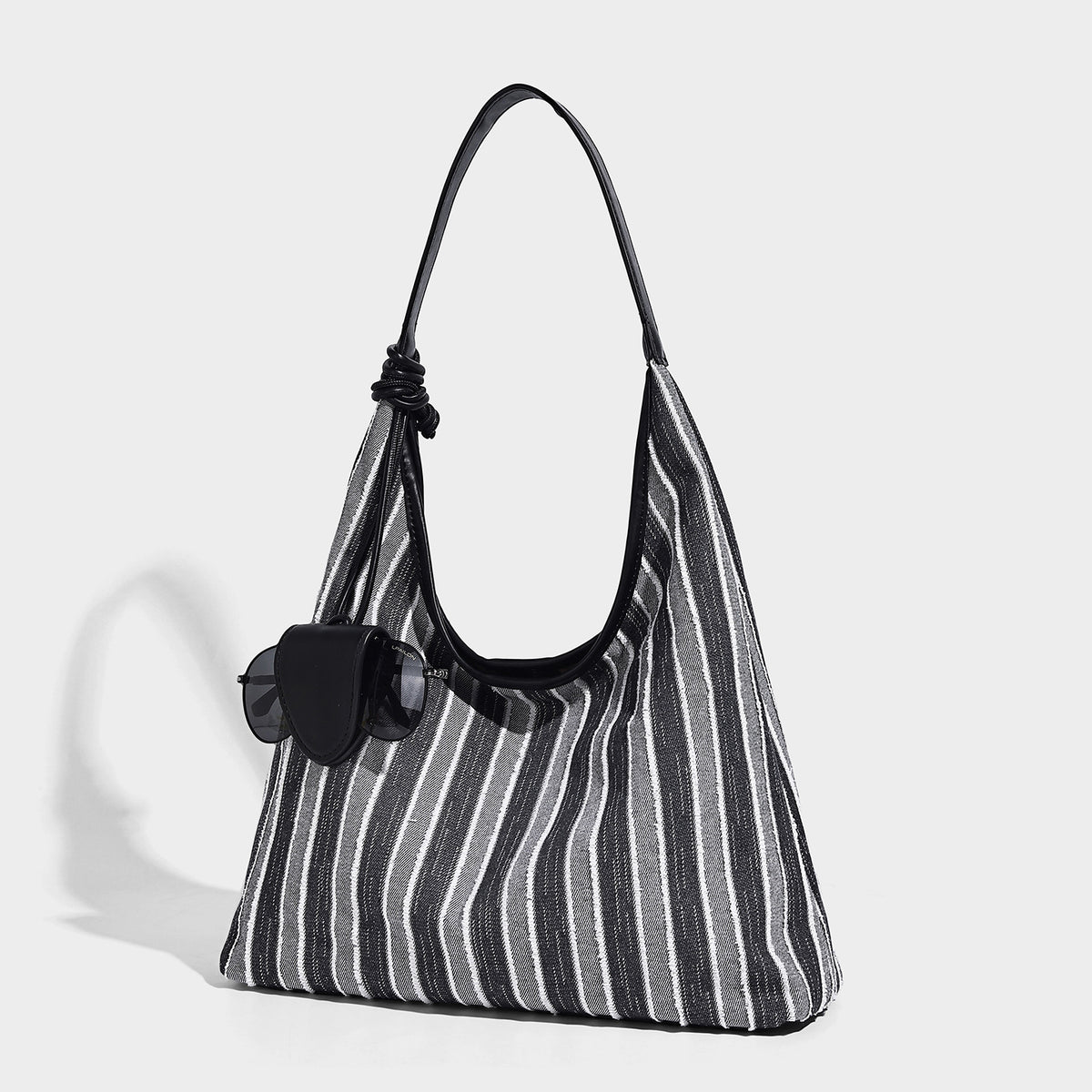 Slouchy striped canvas hobo shoulder bag with cream trim and long knotted strap, detail view 3