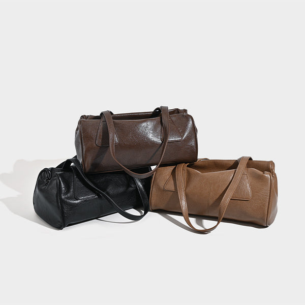 Glossy leather-look barrel shoulder bag with zip closure and top handles, detail view 2