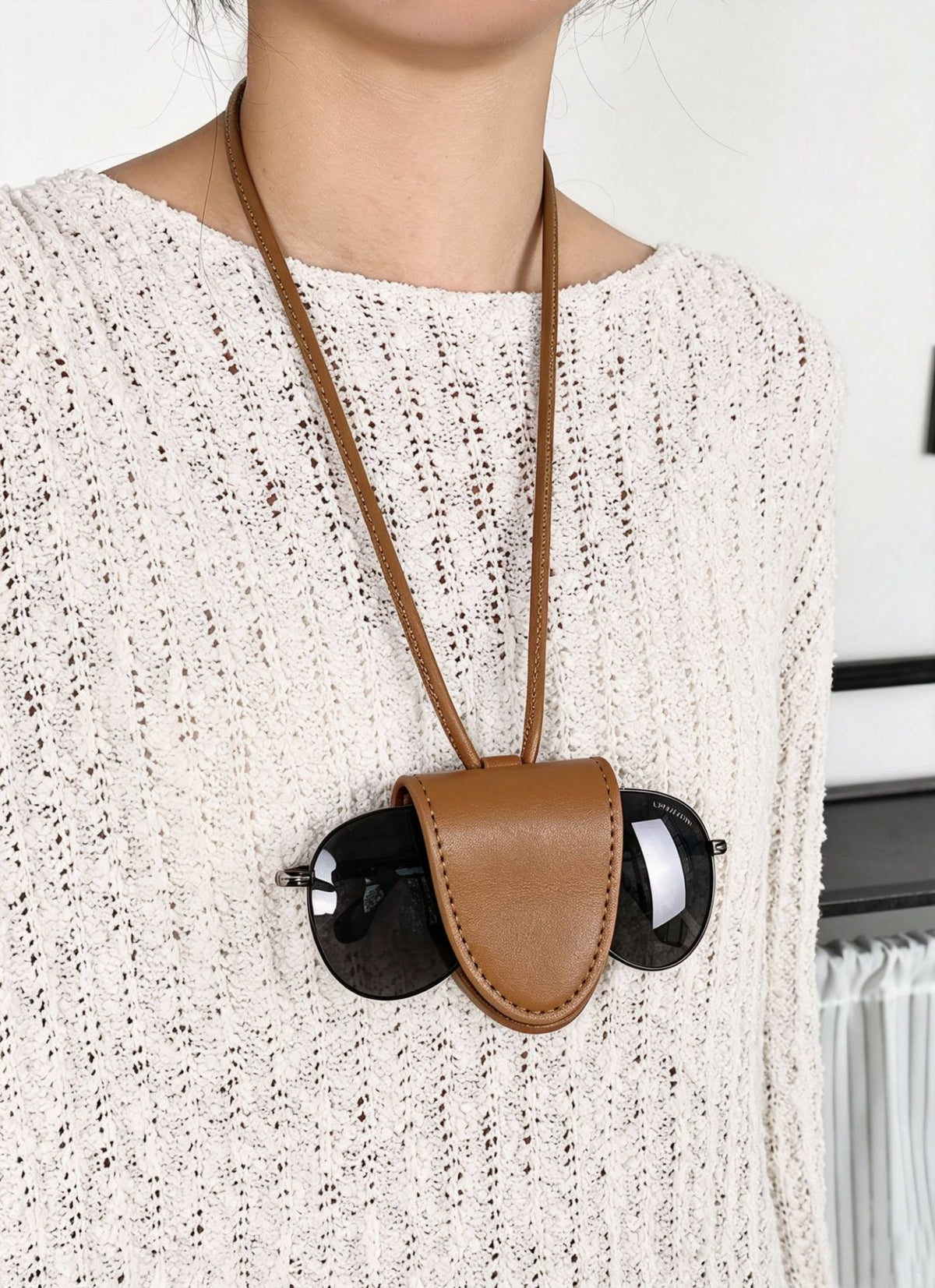 Small structured woven tote crossbody bag with ring top handle, leather-look brown trim, front patch pocket, and detachable