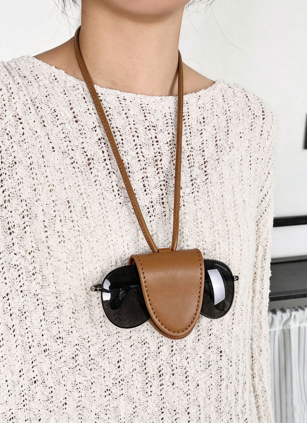 Small structured woven tote crossbody bag with ring top handle, leather-look brown trim, front patch pocket, and detachable