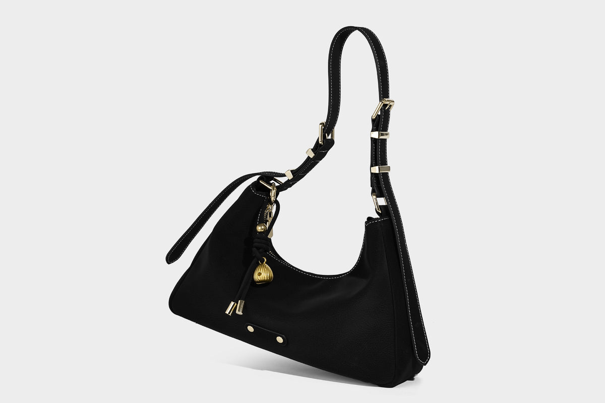Crescent hobo shoulder bag in pebbled leather-look finish with top zipper, adjustable strap, gold-tone ring hardware, and