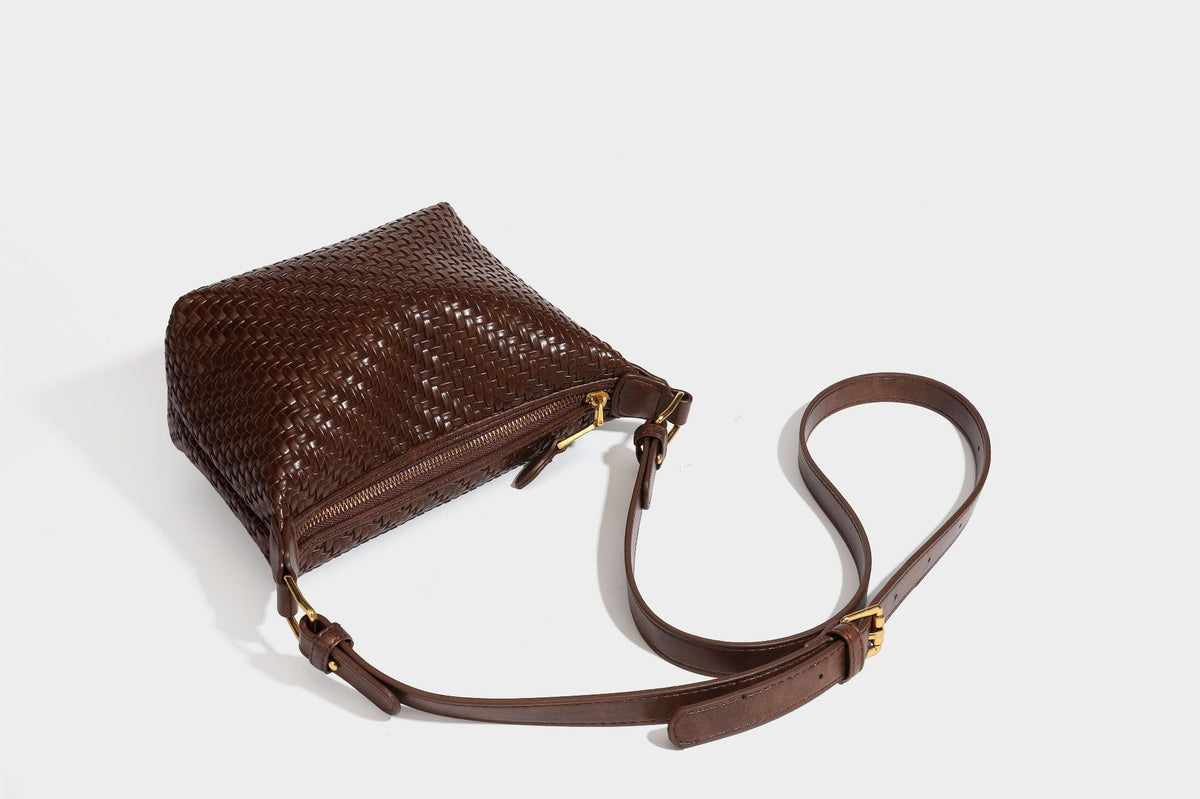 Small glossy basket-weave hobo shoulder bag in brown with knotted top handle, flap accent pocket, and gold-tone hardware