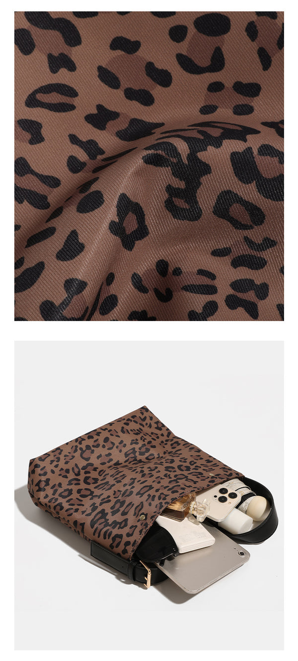 Brown and black leopard print canvas bucket bag with adjustable black leather-look shoulder strap and gold-tone hardware