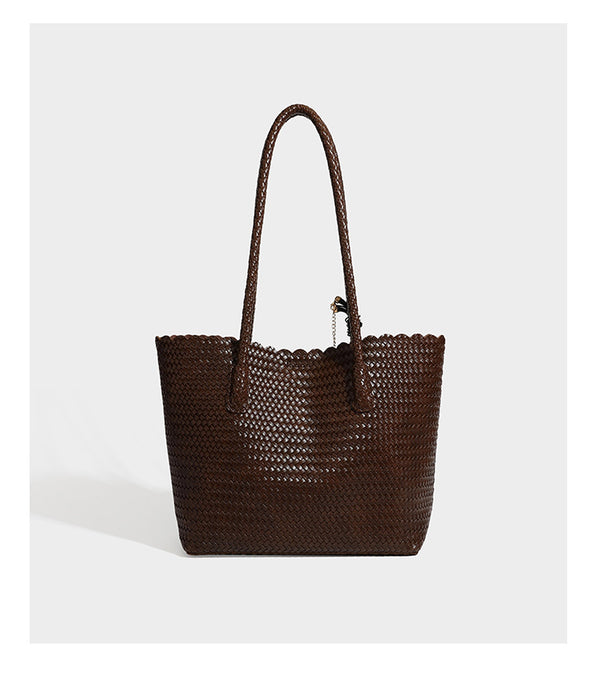 Large open-top woven leather-look tote bag in dark brown with scalloped edge, braided double shoulder straps, and decorative