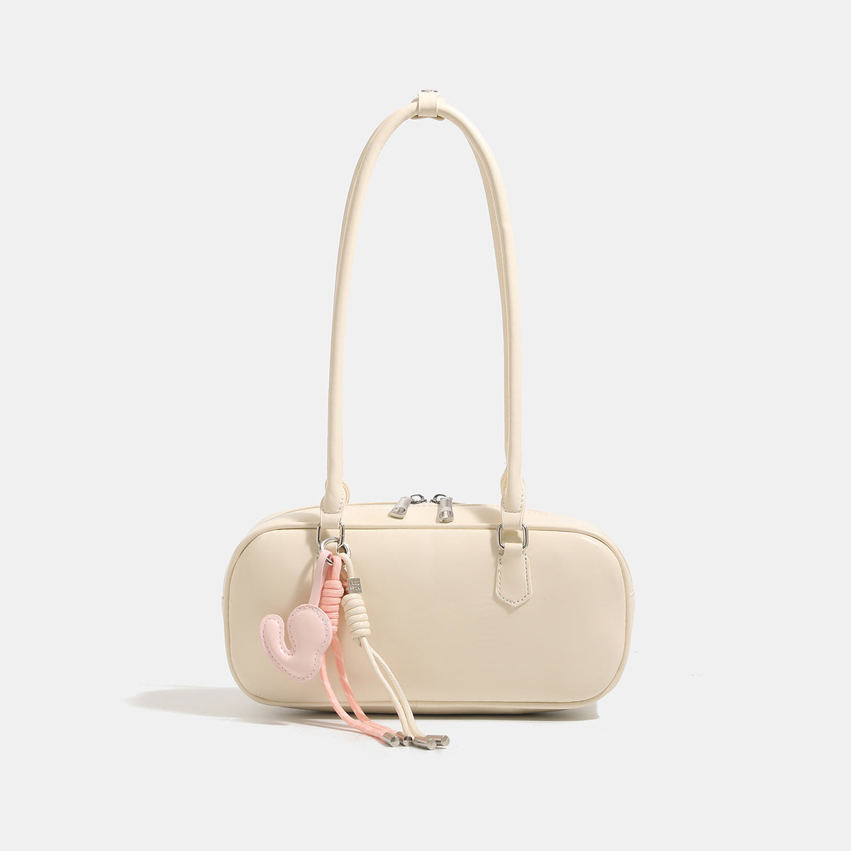 Compact rounded baguette shoulder bag with smooth leather-look finish, slim double straps, silver-tone zipper hardware, and