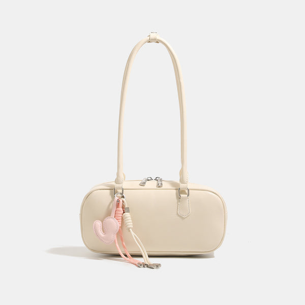Compact rounded baguette shoulder bag with smooth leather-look finish, slim double straps, silver-tone zipper hardware, and
