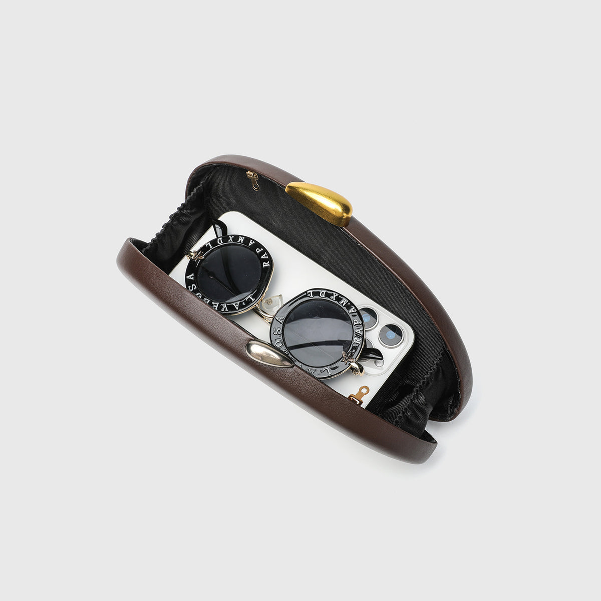 Oval hard-shell crossbody clutch bag with smooth matte leather-look finish and gold-tone snake chain strap, detail view 4