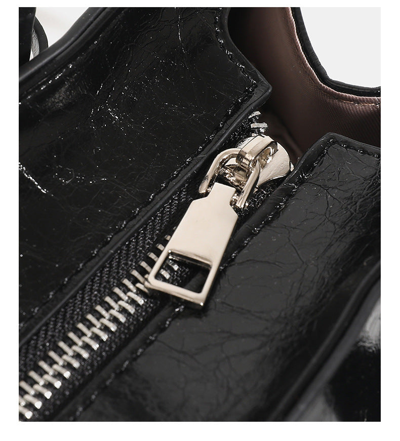 Structured glossy leather-look tote bag with long loop handles and silver turn-lock buckle closure, detail view 15