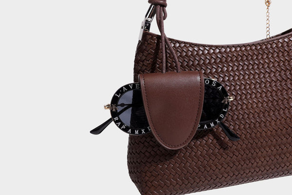 Woven-texture hobo shoulder bag in brown with braided top handle, adjustable crossbody strap, front flap pocket, and, detail