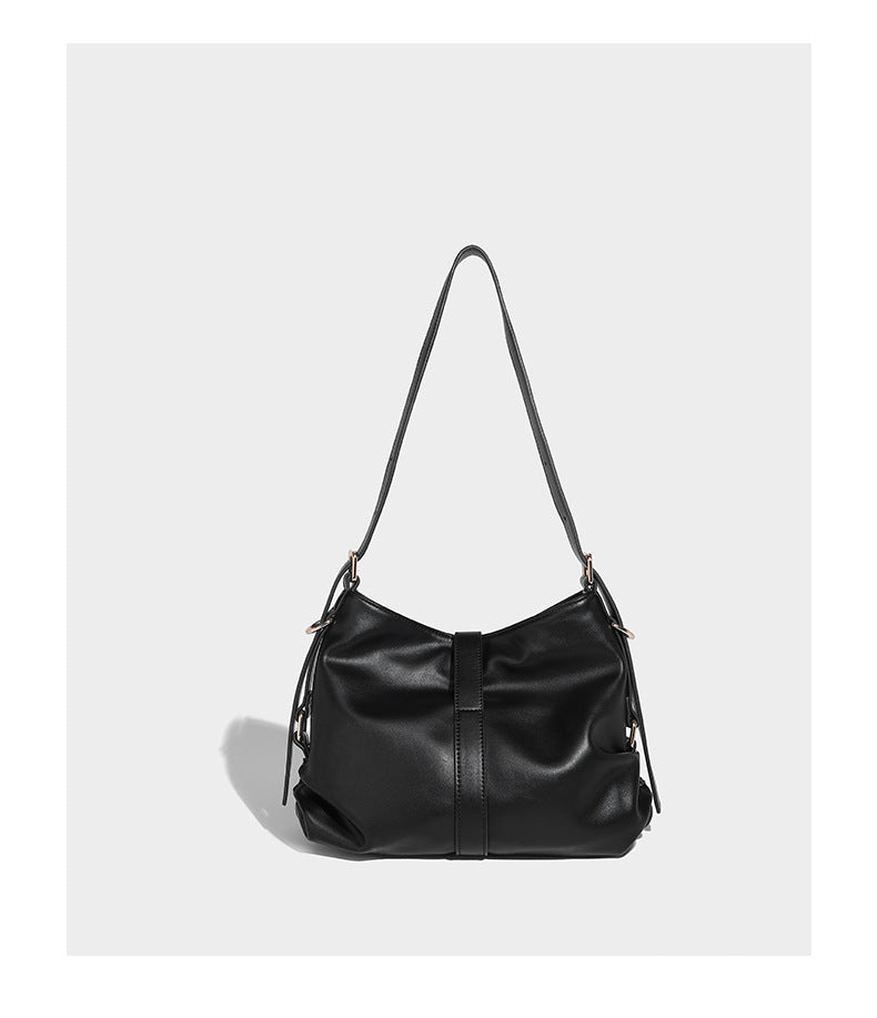 Soft slouchy hobo shoulder bag with smooth leather-look finish, gold-tone buckle and tab hardware, and long adjustable strap