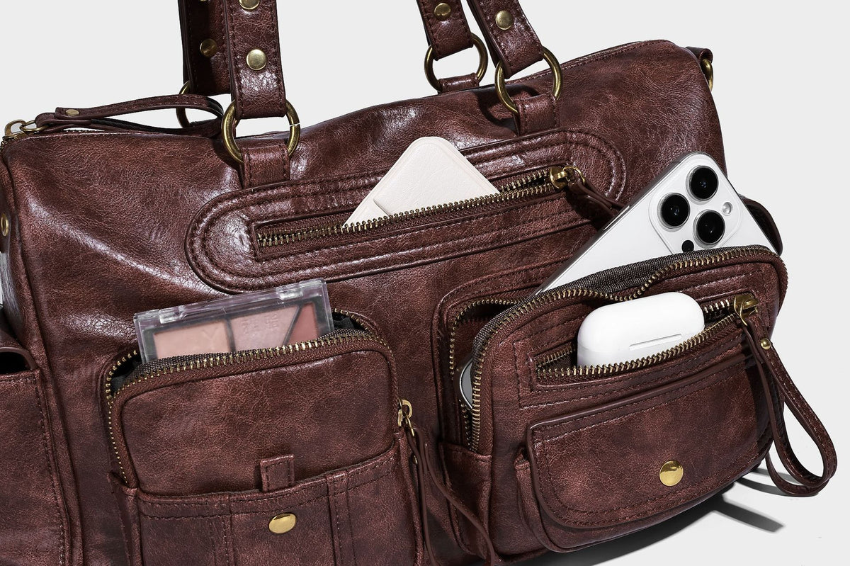 Distressed leather-look vintage satchel shoulder bag with multiple front zip pockets, dual top handles, and brass-tone